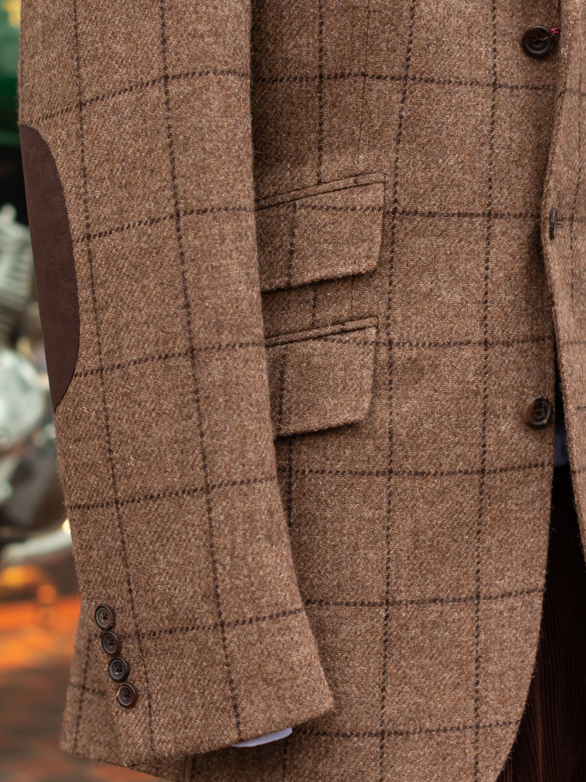 A tweed Hacking jacket showing slanted pockets and ticket pocket